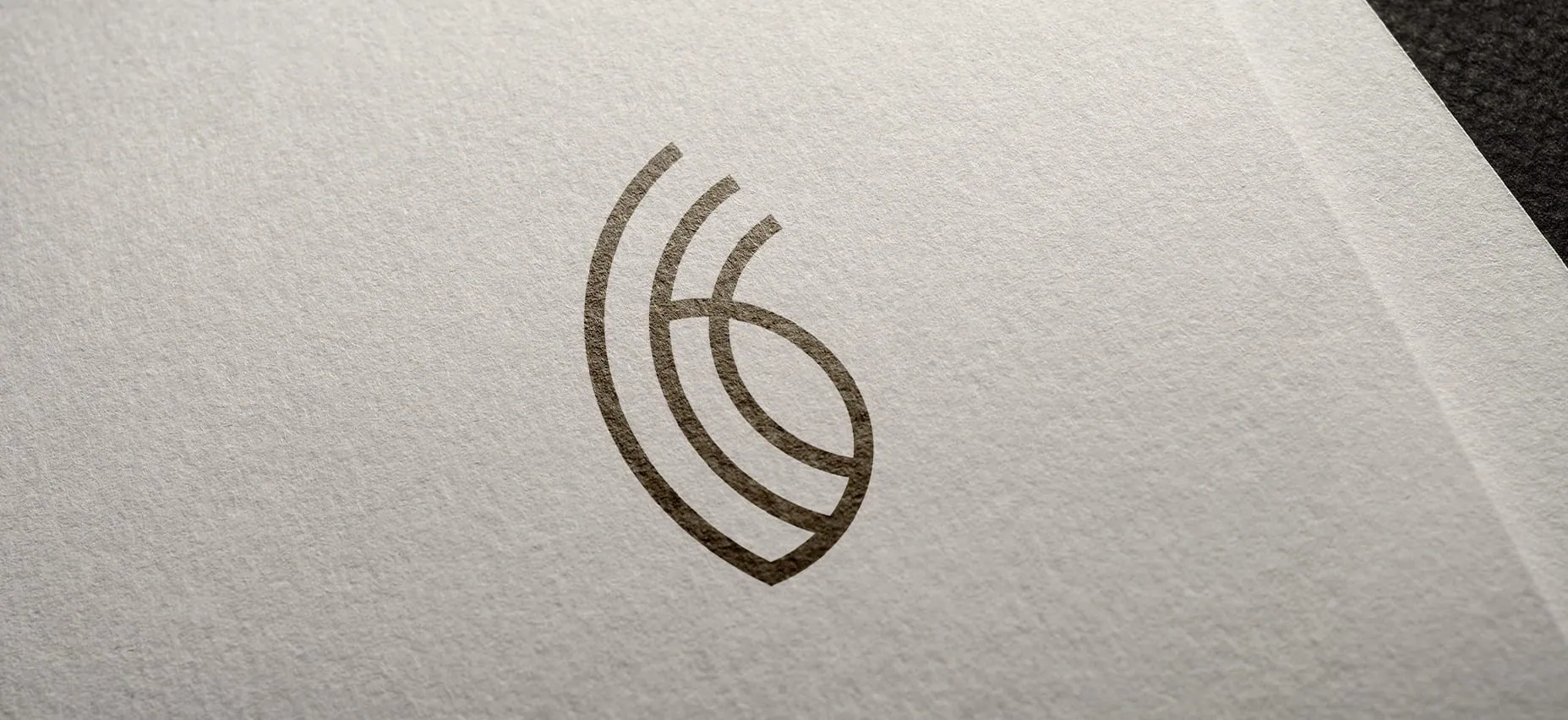 Prancheta 2 curved emblem logo on textured paper